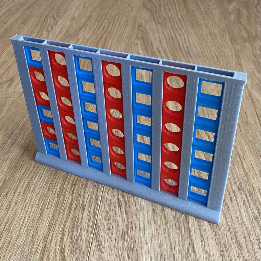 Czwórki Gra czwórki składająca się ze srebrnej planszy, do której wrzucane są prostopadłościenne żetony z wycięciami w kształcie kół i kwadratów