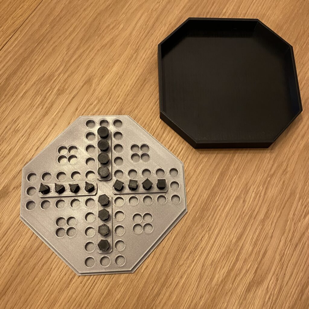 Chińczyk, otwarta plansza Chińczyk: pionki są ustawione na polach startowych. Poszczególne pionki są identyfikowane przez kształt główki: koło, trójkąt, kwadrat lub sześciokąt.